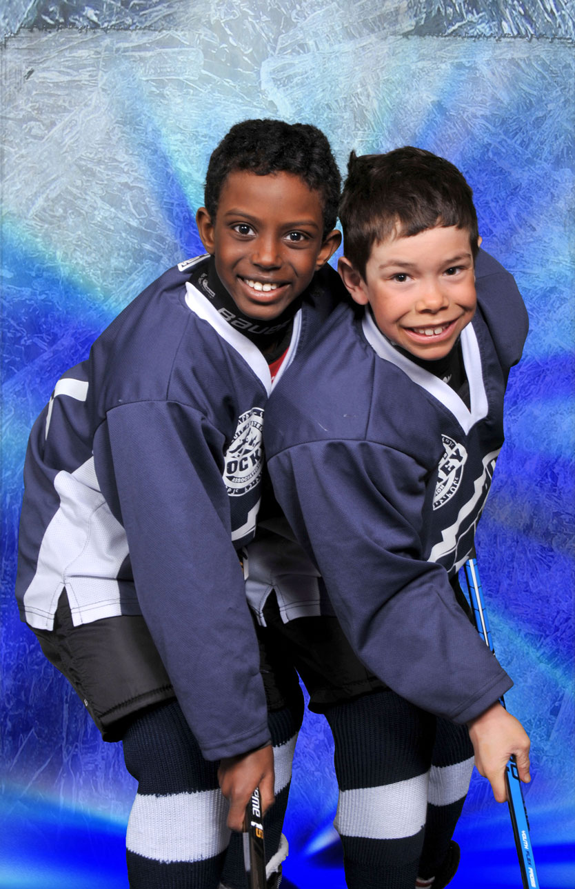 two boys posing in their hockey gear