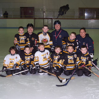 Group portrait of youth hockey team on ice