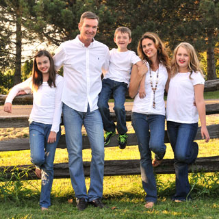 Family posing on fence