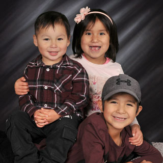 Portrait of 3 children posing in studio